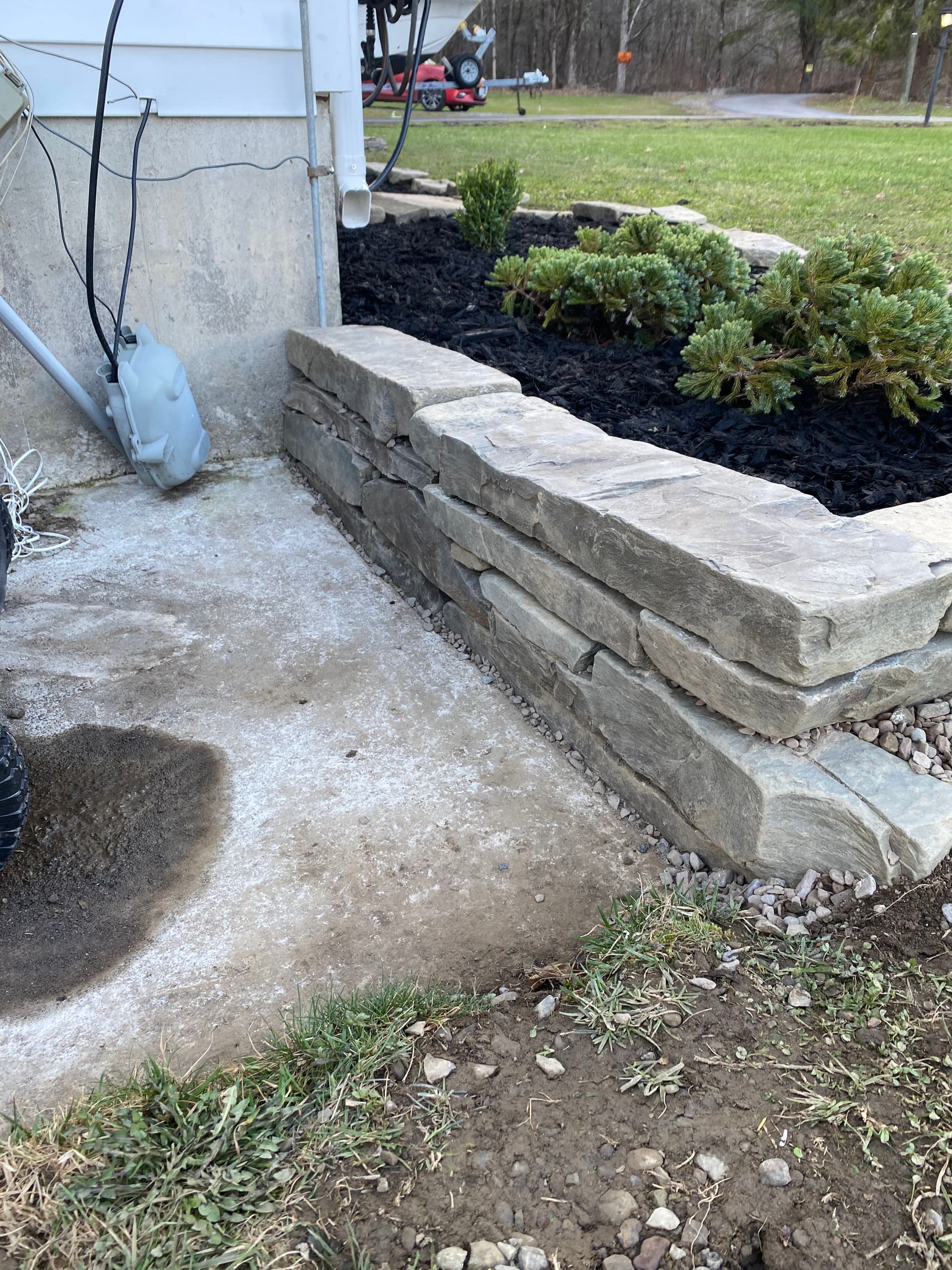 Local Stone Retaining Wall with Mulch Beds and Shrub Install image